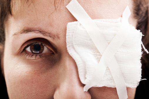 woman with bandaged eye